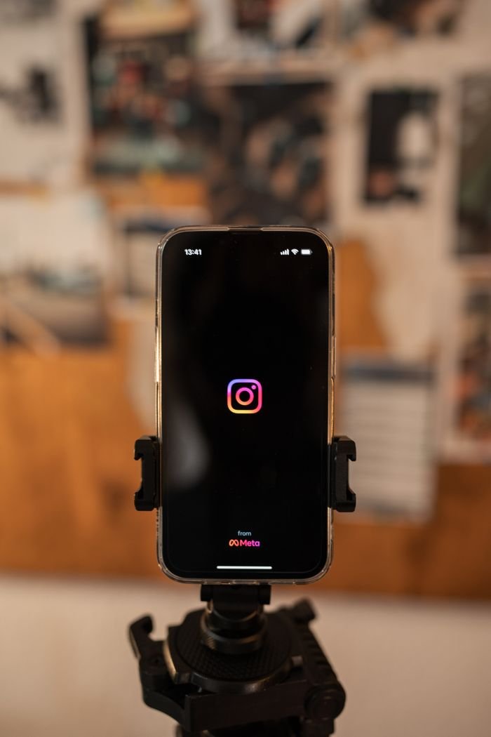 gallery-4 Smartphone displaying Instagram logo on tripod, perfect for social media concepts.