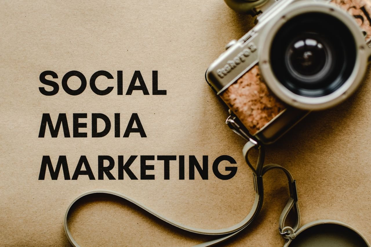 our-services-1 A vintage camera on brown paper with 'SOCIAL MEDIA MARKETING' text, perfect for marketing visuals.